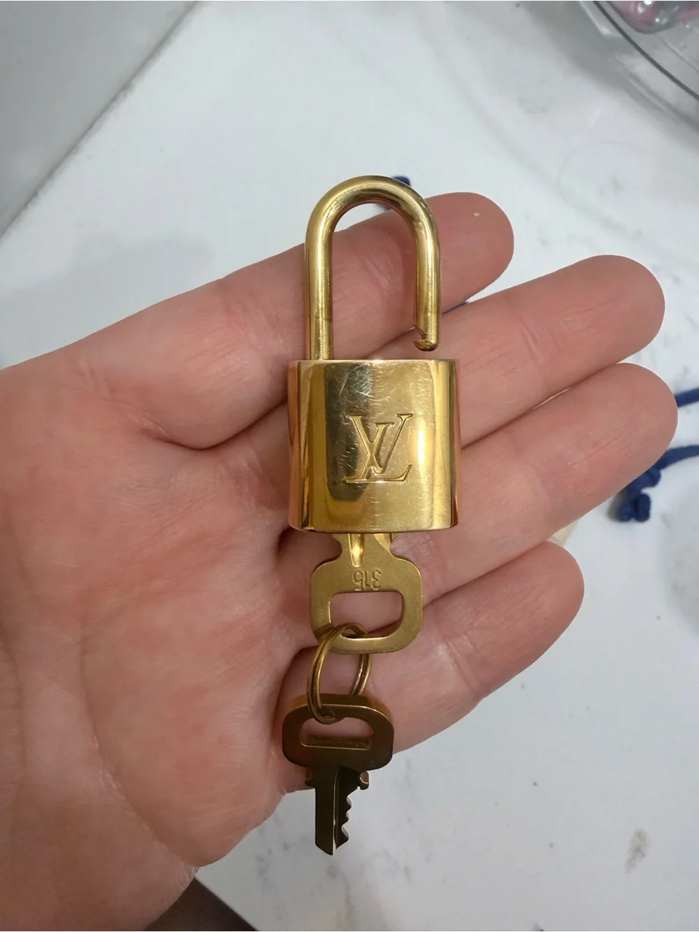 Louis Vuitton Gold Padlock Key Charm with Cream Pouch and Blue Drawstrings